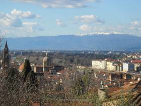 Florence - panoramic view of the "Santo Spirito" church and the snow covered Apenninic ridge