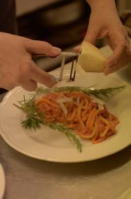 Freshly grated Pecorino cheese over the  "Maccheroncini al Ragù Toscano della Nonna" is a must at "Locanda al Pozzo Antico" in Cortona, Tuscany