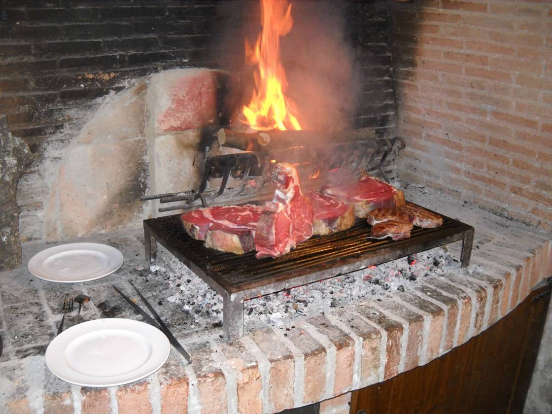 Bistecche Fiorentine on the grill at "Locanda Amordivino" in Asciano